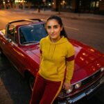 Riley Via with a classic Triumph Stag sports car in red