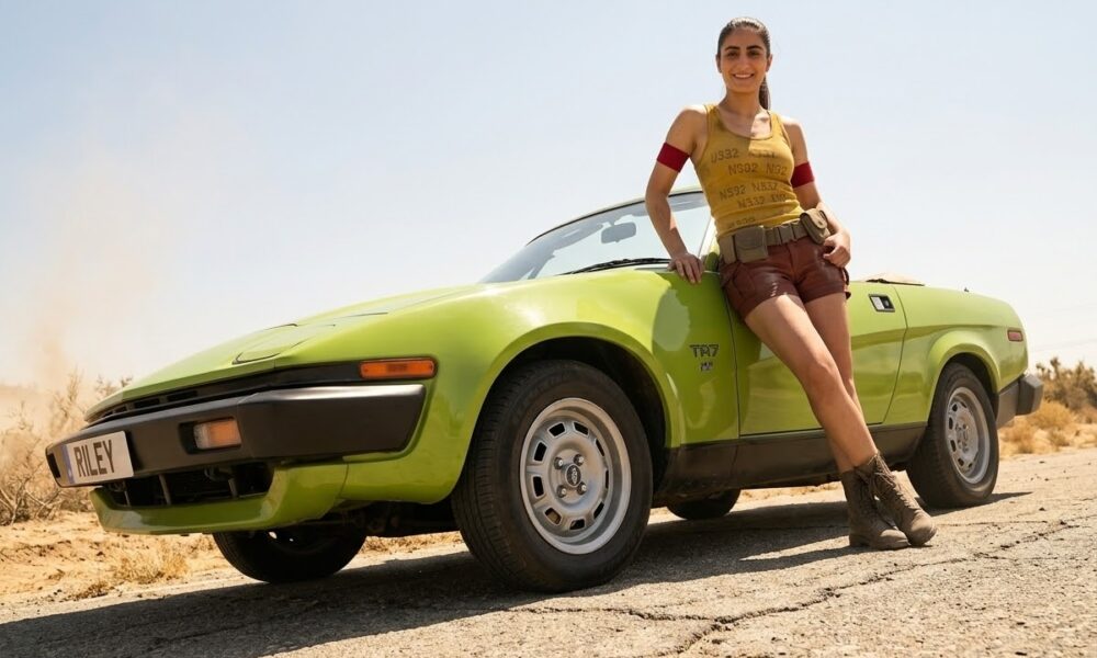 Action Riley poses with her Triumph TR7 classic car