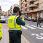 Riley watches a Guardia Civil officer monitoring traffic at a pedestrian crossing