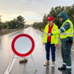 Riley talks to a Guardia Civil officer about the importance of the R-101 road sign in Spain.